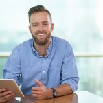 Portrait of happy businessman with tablet pc