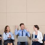 Five Cheerful Business People in Waiting Room