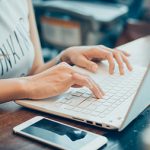 woman’s hands busy working on her laptop