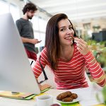 Female graphic designer having a cookie