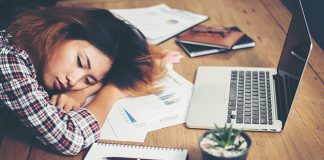 Young hipster woman tired for work and nap on workplace .