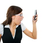 Angry businesswoman shouting to mobile